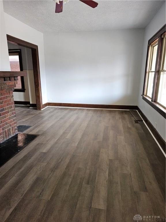 4009 E 3rd St, Dayton, OH 45403 - empty room with dark wood finished floors, a ceiling fan, and a textured ceiling
