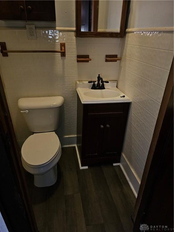 4009 E 3rd St, Dayton, OH 45403 - half bath featuring vanity, tile walls, and wood finished floors