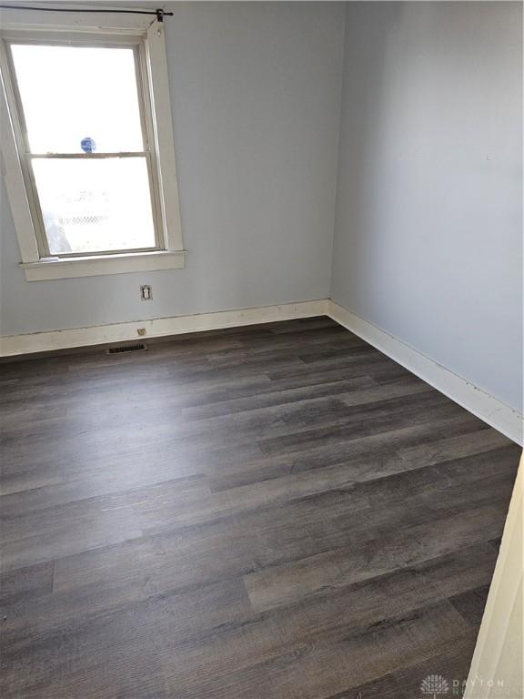 4009 E 3rd St, Dayton, OH 45403 - unfurnished room with dark wood-type flooring and baseboards