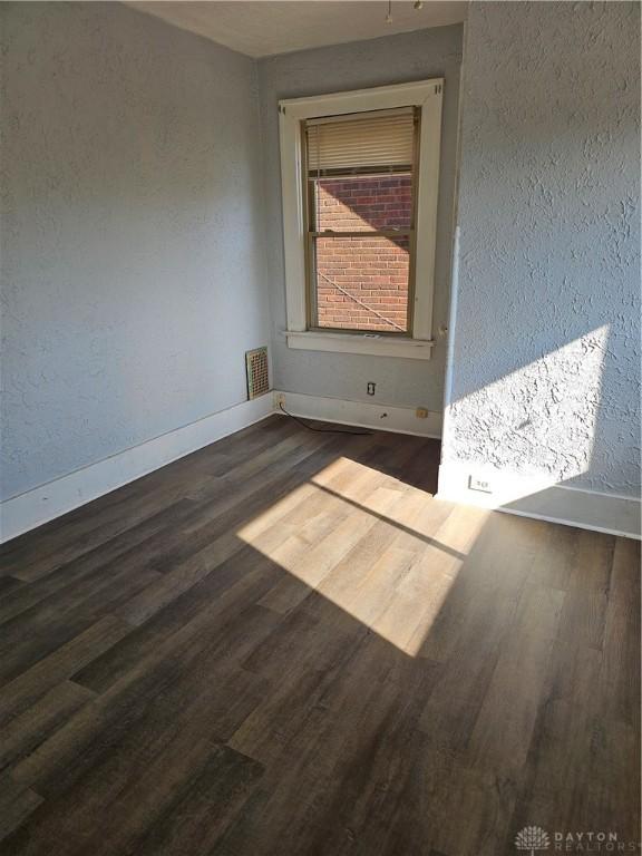 4009 E 3rd St, Dayton, OH 45403 - empty room featuring wood finished floors and a textured wall