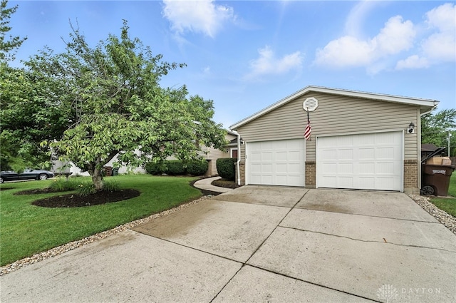 51 Jill Dr, Germantown, OH 45327 - view of side of property with a garage, brick siding, a lawn, and driveway