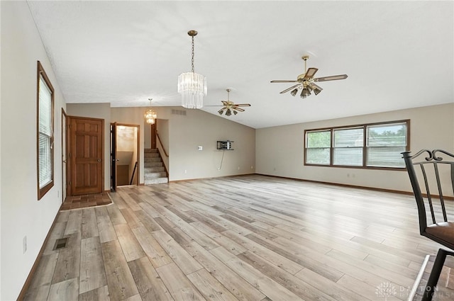 51 Jill Dr, Germantown, OH 45327 - unfurnished living room with light wood-type flooring, stairs, lofted ceiling, a ceiling fan, and a chandelier