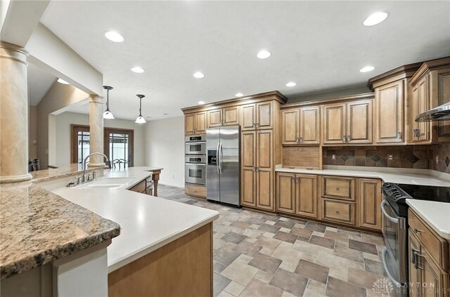 51 Jill Dr, Germantown, OH 45327 - kitchen with appliances with stainless steel finishes, ornate columns, recessed lighting, brown cabinetry, and tasteful backsplash