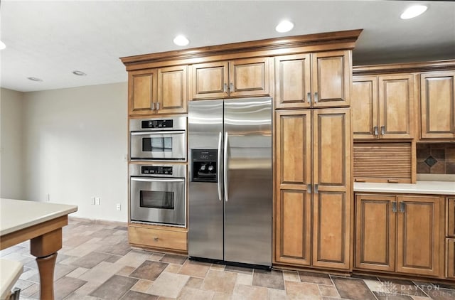 51 Jill Dr, Germantown, OH 45327 - kitchen with appliances with stainless steel finishes, stone finish floors, brown cabinets, recessed lighting, and light countertops