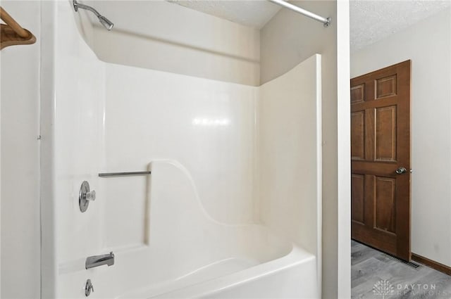51 Jill Dr, Germantown, OH 45327 - full bath with  shower combination, wood finished floors, and a textured ceiling