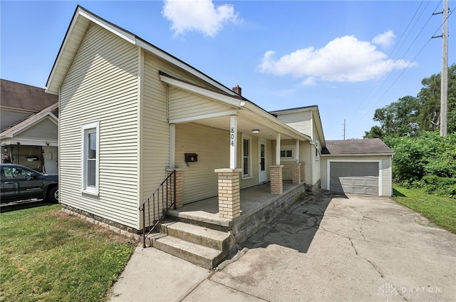 804 S Walnut St, Troy, OH 45373 - view of front facade with a porch, concrete driveway, and an attached garage