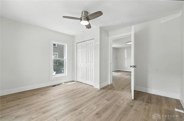 804 S Walnut St, Troy, OH 45373 - unfurnished bedroom featuring light wood-style flooring, a closet, and ceiling fan
