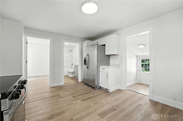 804 S Walnut St, Troy, OH 45373 - kitchen with appliances with stainless steel finishes, white cabinetry, light wood-style floors, and light countertops