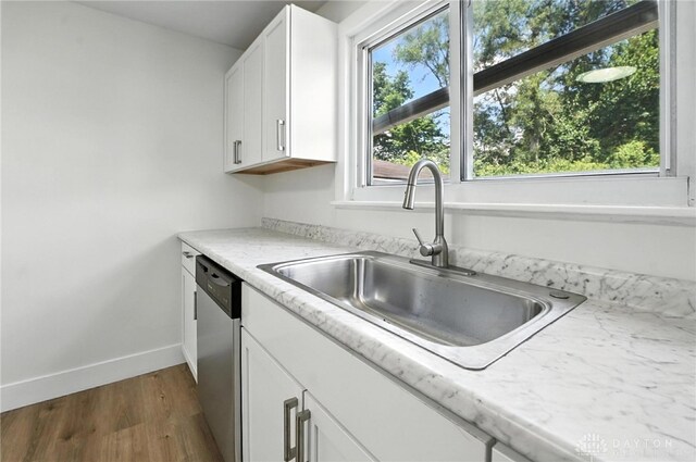 804 S Walnut St, Troy, OH 45373 - kitchen featuring stainless steel dishwasher, dark wood-type flooring, and white cabinets