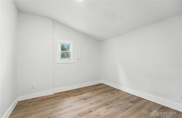 804 S Walnut St, Troy, OH 45373 - spare room featuring vaulted ceiling and light wood-style flooring
