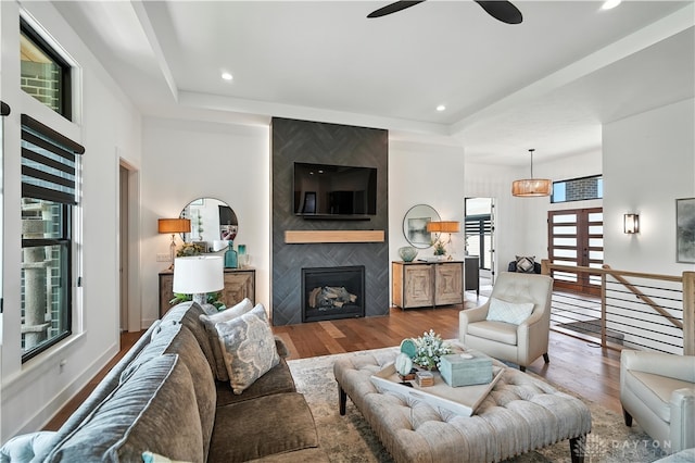 1241 Normandy Rue, Centerville, OH 45458 - living room featuring a ceiling fan, wood finished floors, a tray ceiling, a large fireplace, and recessed lighting