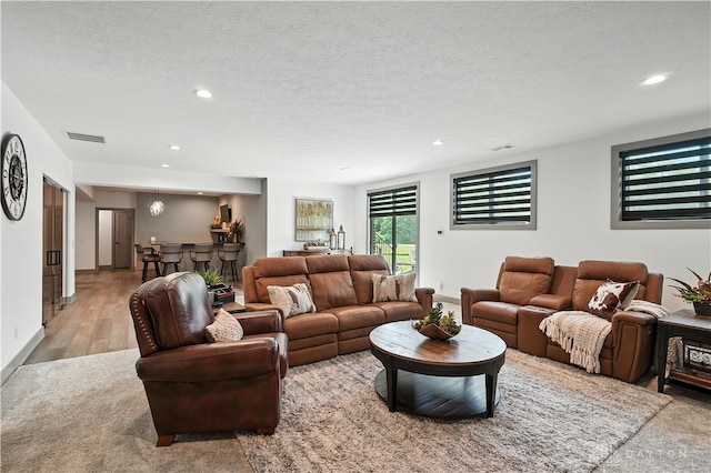 1241 Normandy Rue, Centerville, OH 45458 - living area with recessed lighting, a textured ceiling, light wood-style floors, and light colored carpet