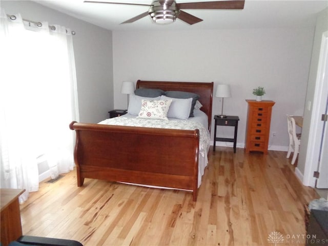 12071 Oxford Rd, Germantown, OH 45327 - bedroom with light wood-style floors, a ceiling fan, and multiple windows