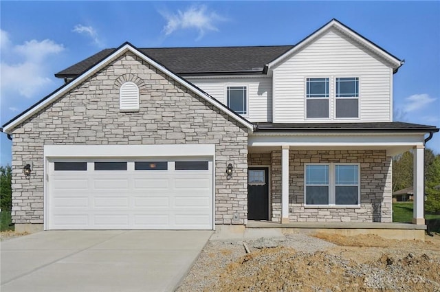 3384 Randall Dr, Cedarville Twp, OH 45314 - view of front of property featuring stone siding, concrete driveway, covered porch, and roof with shingles