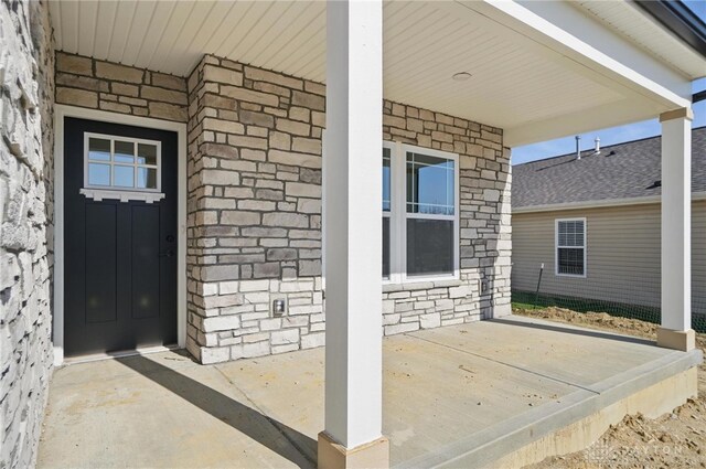 3384 Randall Dr, Cedarville Twp, OH 45314 - entrance to property featuring a porch, stone siding, and brick siding