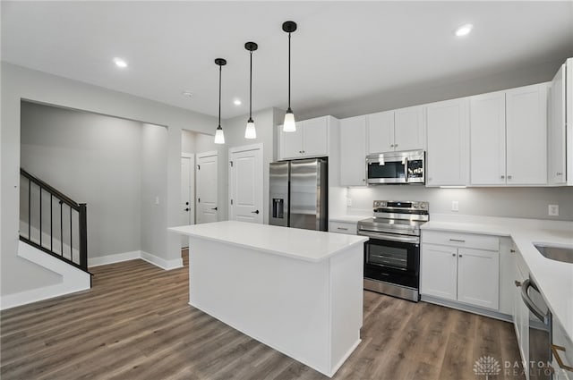 3384 Randall Dr, Cedarville Twp, OH 45314 - kitchen featuring appliances with stainless steel finishes, a kitchen island, dark wood-style floors, recessed lighting, and white cabinetry