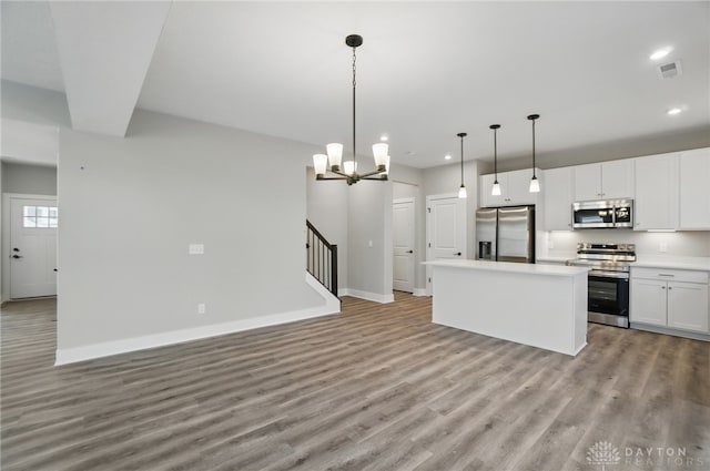 3384 Randall Dr, Cedarville Twp, OH 45314 - kitchen featuring stainless steel appliances, light wood-style flooring, a kitchen island, recessed lighting, and white cabinets
