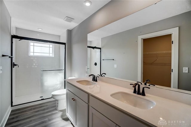 3384 Randall Dr, Cedarville Twp, OH 45314 - full bath with a shower stall, double vanity, a walk in closet, wood finished floors, and recessed lighting
