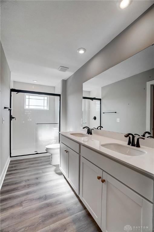 3384 Randall Dr, Cedarville Twp, OH 45314 - bathroom featuring a stall shower, double vanity, wood finished floors, and recessed lighting