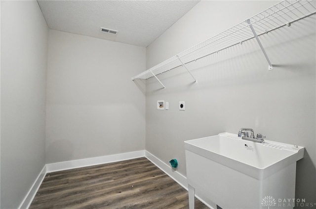 3384 Randall Dr, Cedarville Twp, OH 45314 - washroom featuring washer hookup, dark wood-style floors, hookup for an electric dryer, and a textured ceiling