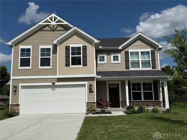 562 Maxwell Ct, Germantown, OH 45327 - craftsman-style house featuring stone siding, driveway, an attached garage, a front lawn, and covered porch