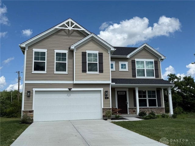 562 Maxwell Ct, Germantown, OH 45327 - craftsman-style home featuring stone siding, an attached garage, a front yard, and driveway