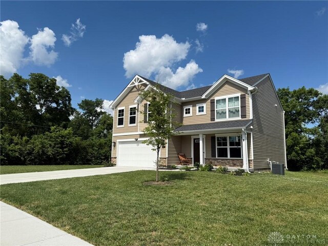 562 Maxwell Ct, Germantown, OH 45327 - craftsman house with an attached garage, driveway, a front yard, a porch, and stone siding