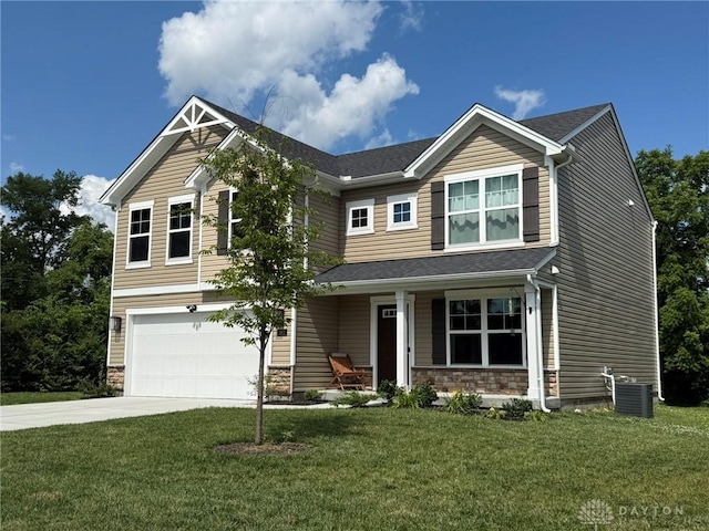 562 Maxwell Ct, Germantown, OH 45327 - craftsman inspired home featuring an attached garage, concrete driveway, covered porch, stone siding, and a front lawn
