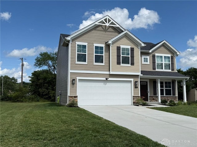 562 Maxwell Ct, Germantown, OH 45327 - craftsman-style house featuring a garage, driveway, a front yard, stone siding, and a porch