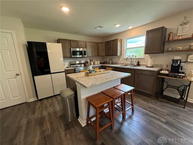 562 Maxwell Ct, Germantown, OH 45327 - kitchen with stainless steel appliances, dark wood-type flooring, light countertops, a center island, and recessed lighting