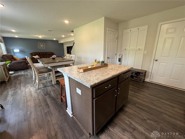 562 Maxwell Ct, Germantown, OH 45327 - kitchen with dark wood-type flooring, open floor plan, a kitchen island, dark brown cabinets, and light countertops