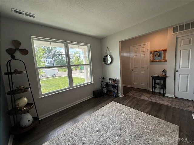 562 Maxwell Ct, Germantown, OH 45327 - entrance foyer with healthy amount of natural light, dark wood-style floors, and a textured ceiling