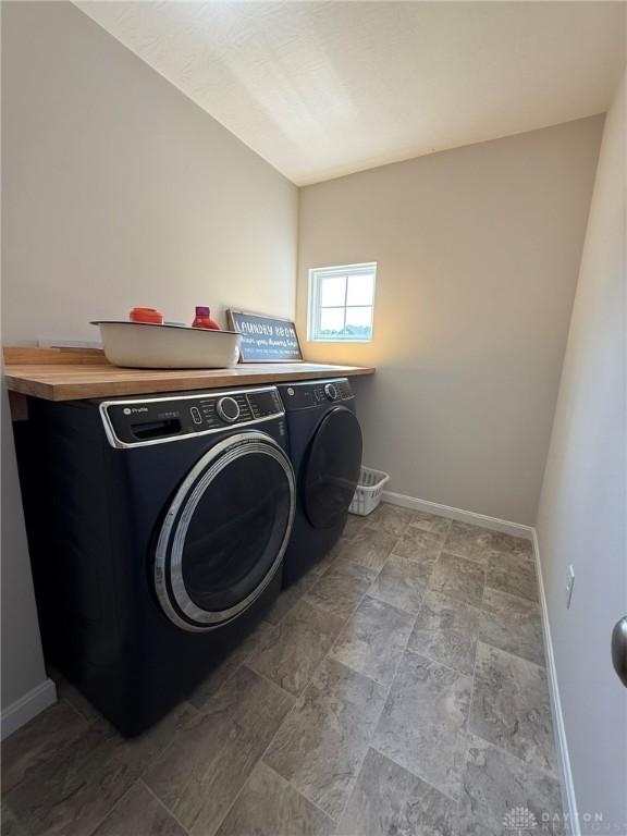 562 Maxwell Ct, Germantown, OH 45327 - laundry room with separate washer and dryer and stone finish floors