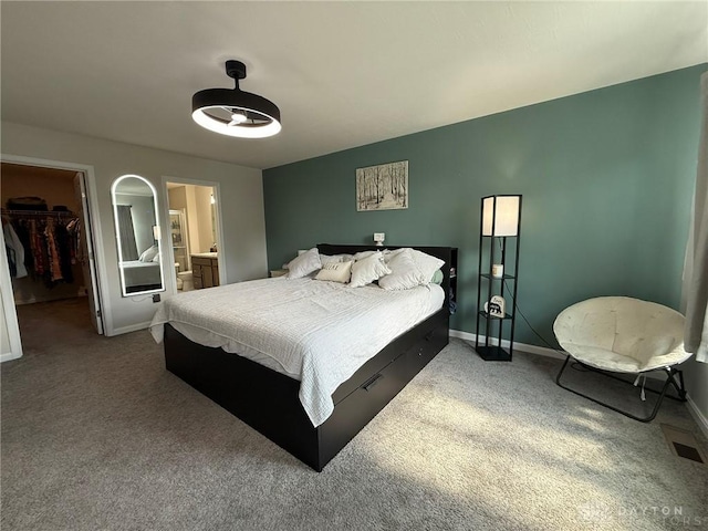 562 Maxwell Ct, Germantown, OH 45327 - bedroom with a spacious closet, dark colored carpet, a closet, and connected bathroom