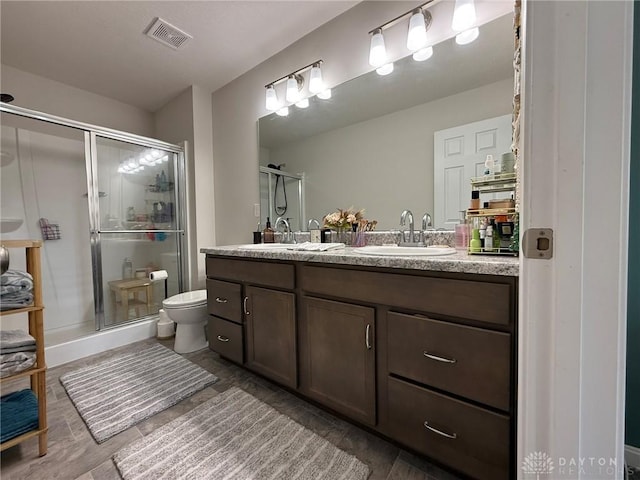 562 Maxwell Ct, Germantown, OH 45327 - bathroom featuring double vanity, a shower stall, and wood finished floors