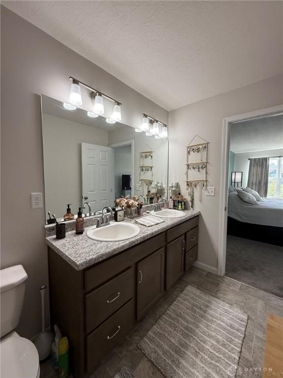 562 Maxwell Ct, Germantown, OH 45327 - ensuite bathroom featuring double vanity and a textured ceiling