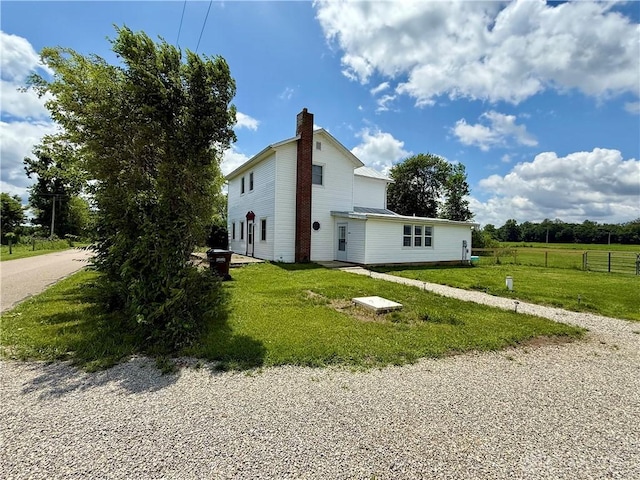 10995 Rockridge Rd, Lewisburg, OH 45338 - view of property exterior with a chimney