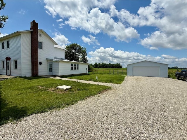 10995 Rockridge Rd, Lewisburg, OH 45338 - view of home's exterior with an outdoor structure, a garage, and a chimney