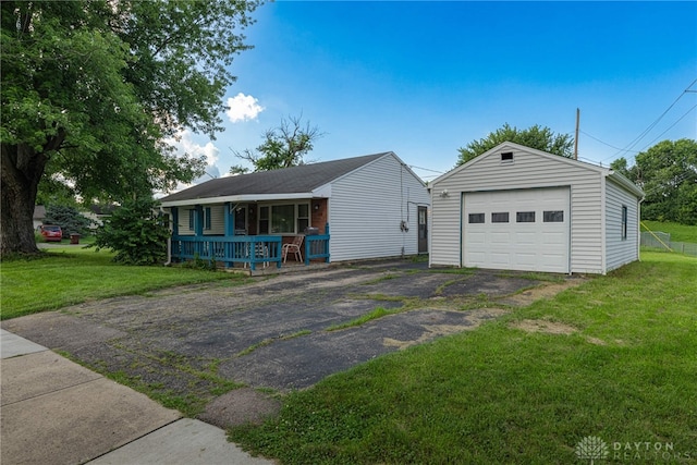 2701 Mini Ct, Dayton, OH 45420 - view of front facade featuring an outdoor structure, a detached garage, asphalt driveway, and a front lawn