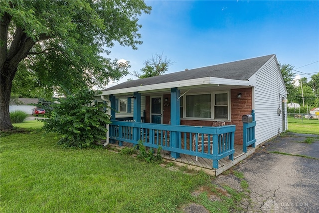 2701 Mini Ct, Dayton, OH 45420 - view of front of property with a porch, a front yard, and roof with shingles