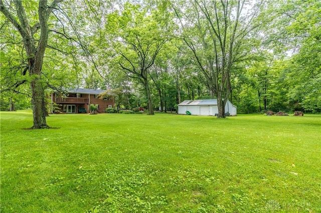 4267 W Wenger Rd, Clayton, OH 45315 - view of grassy yard featuring a detached garage and an outdoor structure