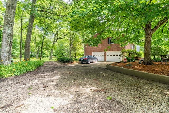 4267 W Wenger Rd, Clayton, OH 45315 - view of property exterior featuring a garage, driveway, and brick siding