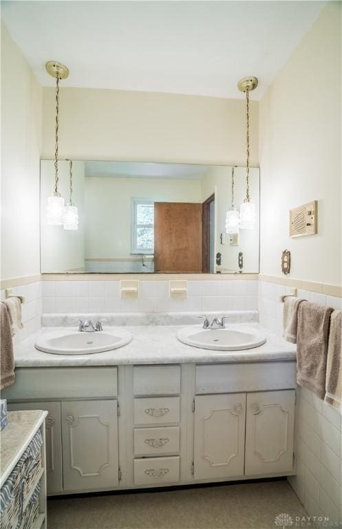 4267 W Wenger Rd, Clayton, OH 45315 - full bath with double vanity, tile walls, and a wainscoted wall