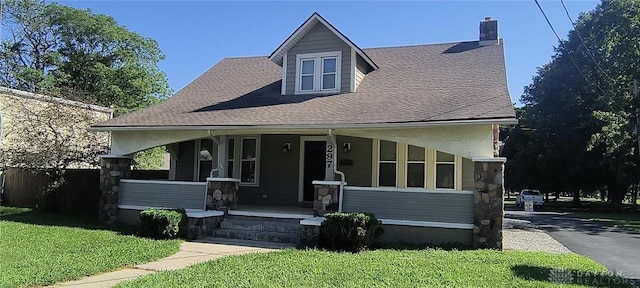 289 Dayton Ave, Xenia, OH 45385 - view of front facade with a porch, a front yard, and stone siding
