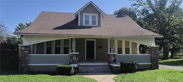 289 Dayton Ave, Xenia, OH 45385 - view of front of home featuring a porch, stone siding, a chimney, and a front lawn
