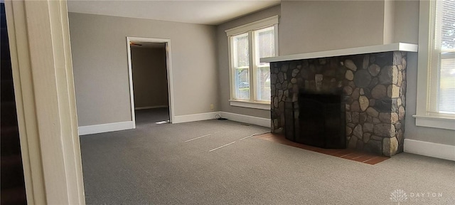 289 Dayton Ave, Xenia, OH 45385 - unfurnished living room with carpet and a stone fireplace