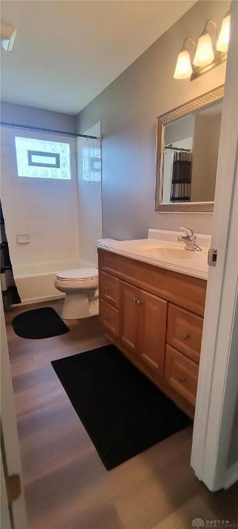 289 Dayton Ave, Xenia, OH 45385 - bathroom featuring vanity, wood finished floors, and shower / tub combo with curtain