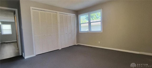 289 Dayton Ave, Xenia, OH 45385 - unfurnished bedroom featuring dark colored carpet and baseboards