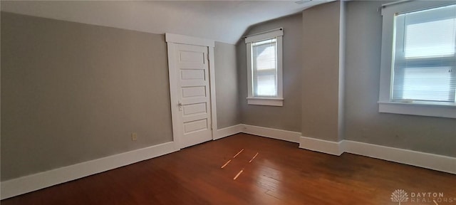 289 Dayton Ave, Xenia, OH 45385 - unfurnished room with dark wood-style flooring and vaulted ceiling