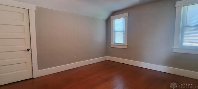 289 Dayton Ave, Xenia, OH 45385 - empty room featuring vaulted ceiling, dark wood finished floors, and plenty of natural light